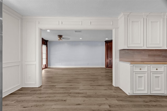 331 Terminal St, Houston, TX 77020 - interior space with visible vents, white cabinets, tasteful backsplash, a ceiling fan, and light wood-style flooring