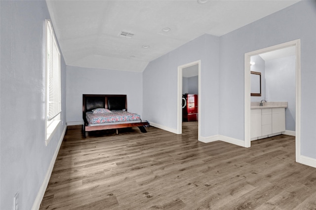 331 Terminal St, Houston, TX 77020 - bedroom featuring visible vents, a sink, baseboards, and wood finished floors