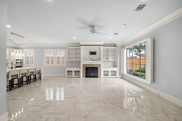 unfurnished living room with crown molding, visible vents, a wealth of natural light, and marble finish floor
