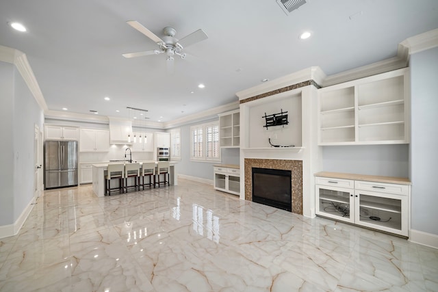 living room with crown molding, visible vents, marble finish floor, baseboards, and ceiling fan