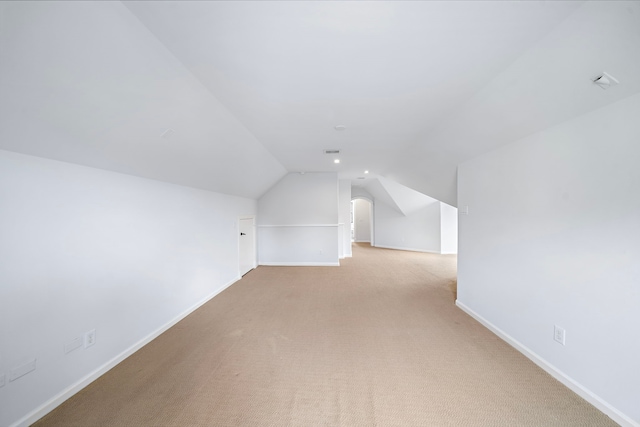 additional living space with baseboards, carpet, and lofted ceiling