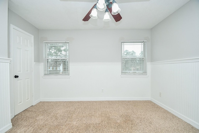 709 N Rivershire Dr, Conroe, TX 77304 - carpeted empty room featuring a wainscoted wall and ceiling fan