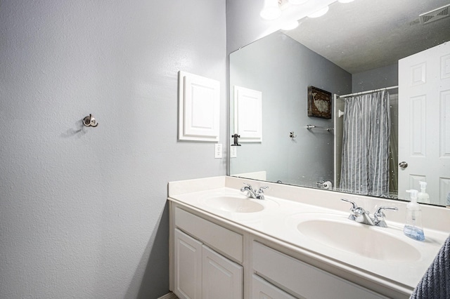 4604 Chaperel Dr, Pearland, TX 77584 - full bath with double vanity, a textured wall, and curtained shower