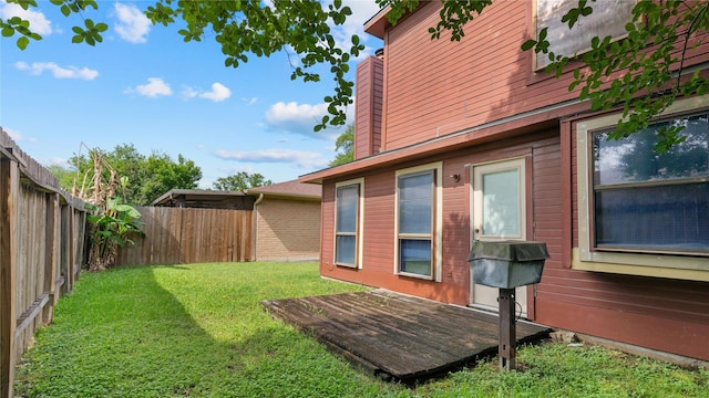 view of yard with a fenced backyard and a wooden deck