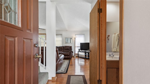 foyer entrance featuring wood finished floors and stairway
