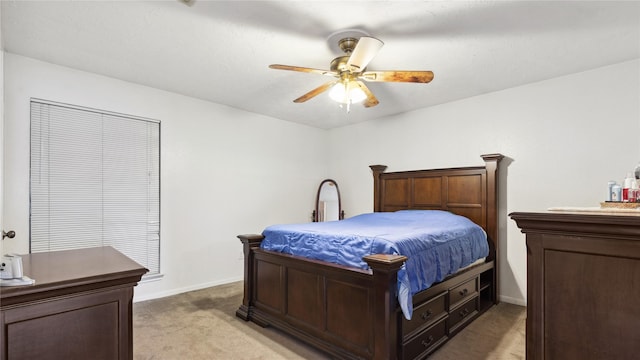 bedroom with light colored carpet, a ceiling fan, and baseboards