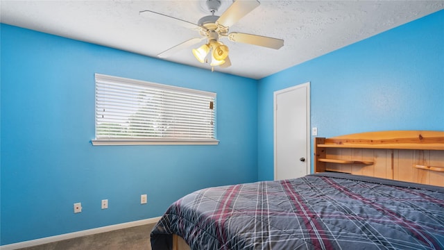 bedroom featuring carpet floors, baseboards, a ceiling fan, and a textured ceiling