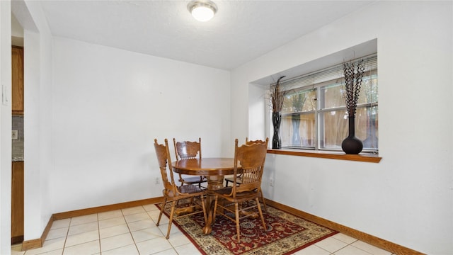 dining room with light tile patterned floors and baseboards