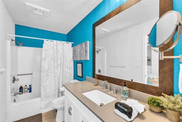 full bathroom with vanity, visible vents, shower / bath combo with shower curtain, toilet, and tile patterned floors