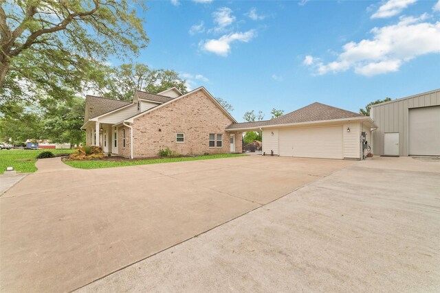 6820 Cemetary Rd, Manvel, TX 77578 - view of property exterior featuring driveway, a garage, and brick siding