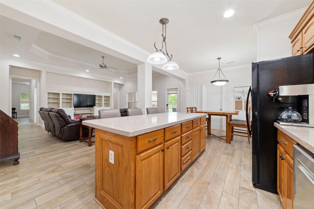 6820 Cemetary Rd, Manvel, TX 77578 - kitchen with a kitchen island, crown molding, a ceiling fan, pendant lighting, and light wood-style floors