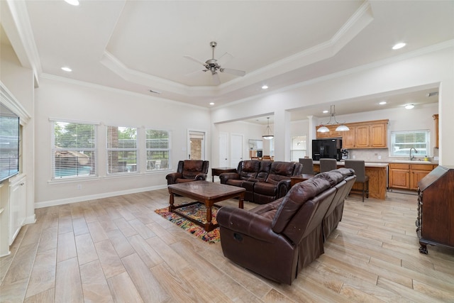 6820 Cemetary Rd, Manvel, TX 77578 - living room featuring light wood-style flooring, a raised ceiling, ceiling fan, recessed lighting, and crown molding