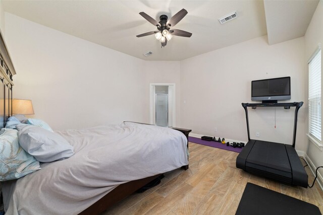 6820 Cemetary Rd, Manvel, TX 77578 - bedroom featuring light wood-type flooring, multiple windows, baseboards, and a ceiling fan