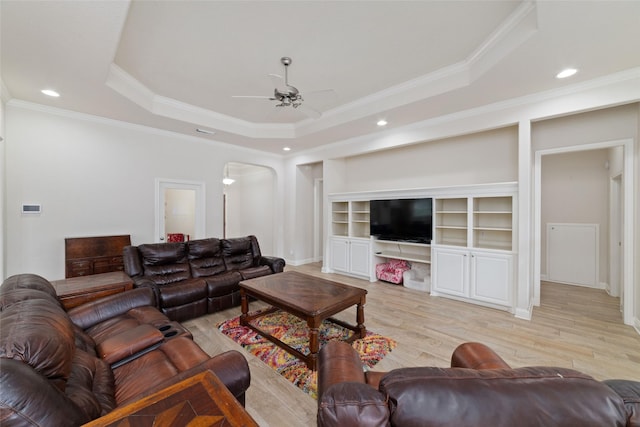 6820 Cemetary Rd, Manvel, TX 77578 - living area featuring arched walkways, a ceiling fan, crown molding, light wood-style flooring, and a raised ceiling