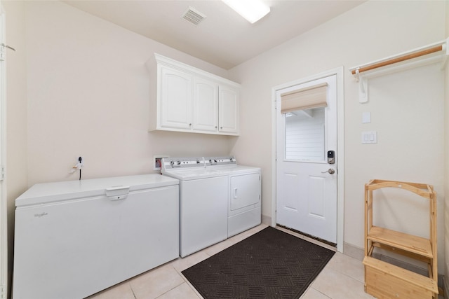 6820 Cemetary Rd, Manvel, TX 77578 - clothes washing area featuring washer and clothes dryer, cabinet space, and light tile patterned flooring
