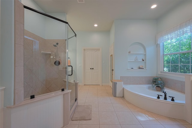 bathroom featuring a garden tub, a stall shower, built in shelves, tile patterned floors, and recessed lighting