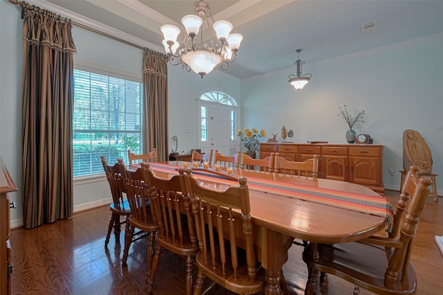 dining room with visible vents, wood finished floors, a healthy amount of sunlight, and an inviting chandelier