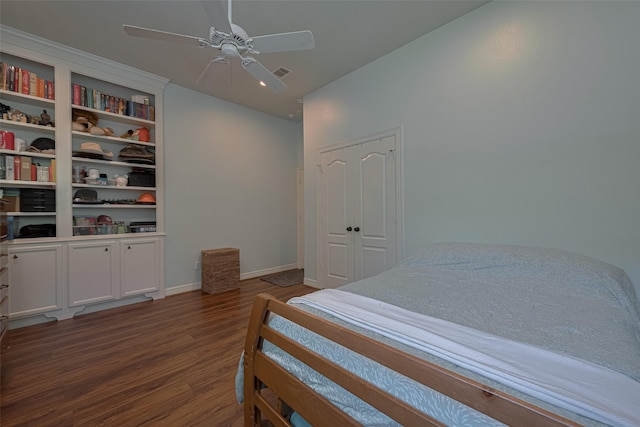 bedroom with baseboards, ceiling fan, wood finished floors, and visible vents