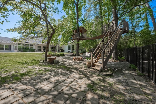 view of yard featuring stairs, fence, and a patio