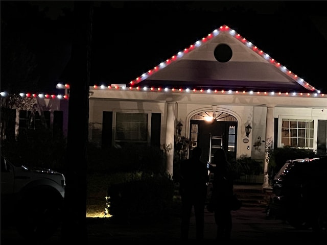 view of back of house at night