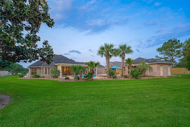 view of yard featuring fence and a fenced in pool