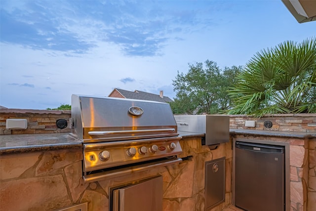 view of patio / terrace featuring exterior kitchen and a grill