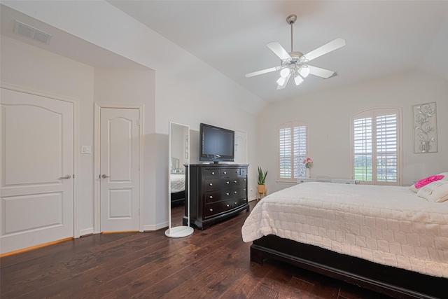 bedroom with visible vents, dark wood-style flooring, baseboards, a ceiling fan, and vaulted ceiling
