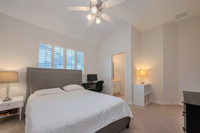 bedroom featuring a ceiling fan, light colored carpet, visible vents, lofted ceiling, and ensuite bath