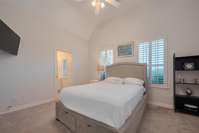 carpeted bedroom featuring baseboards, ceiling fan, ensuite bath, and vaulted ceiling