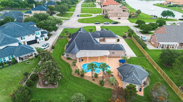 birds eye view of property with a water view and a residential view