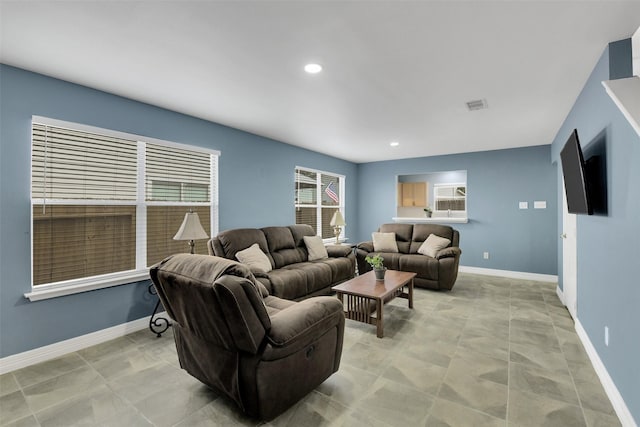 living area featuring baseboards, recessed lighting, and visible vents