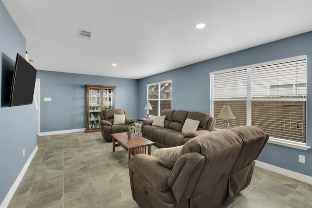 living area with baseboards, recessed lighting, and visible vents