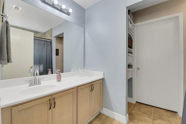 bathroom with vanity, tile patterned floors, baseboards, curtained shower, and visible vents
