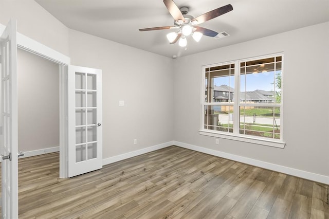 32307 Fly Fish Way, Fulshear, TX 77441 - spare room featuring visible vents, light wood-style flooring, baseboards, and french doors