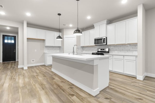 32307 Fly Fish Way, Fulshear, TX 77441 - kitchen with appliances with stainless steel finishes, a sink, baseboards, light countertops, and white cabinetry