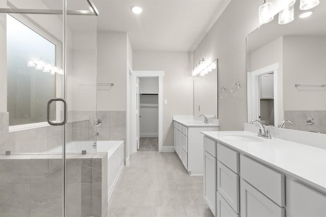32307 Fly Fish Way, Fulshear, TX 77441 - bathroom featuring a garden tub, a sink, two vanities, and tile patterned floors