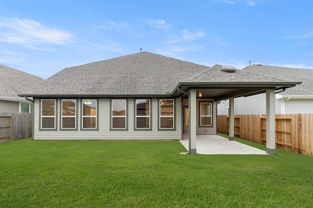 32307 Fly Fish Way, Fulshear, TX 77441 - back of house featuring a lawn, a fenced backyard, a patio area, and a shingled roof