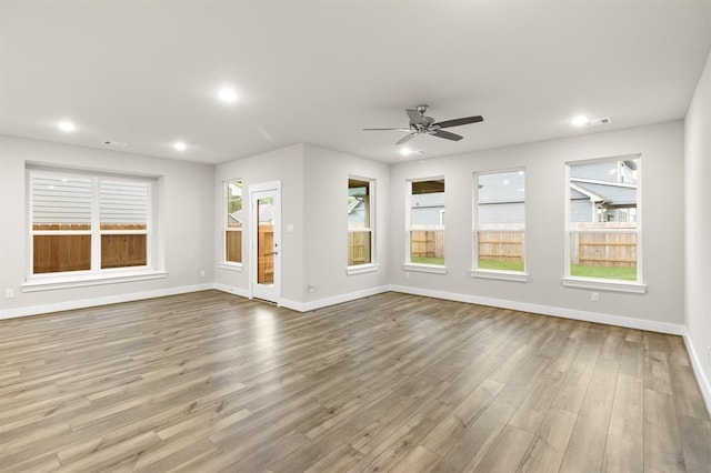 32307 Fly Fish Way, Fulshear, TX 77441 - unfurnished living room featuring recessed lighting, baseboards, ceiling fan, and wood finished floors