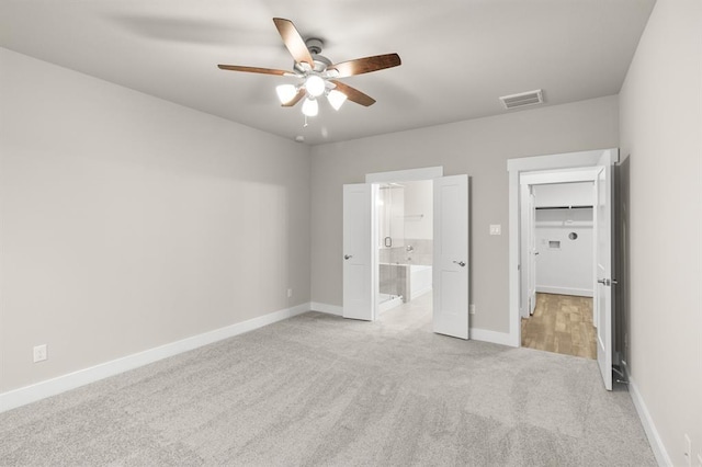 32307 Fly Fish Way, Fulshear, TX 77441 - unfurnished bedroom featuring light colored carpet, visible vents, baseboards, a spacious closet, and ensuite bathroom