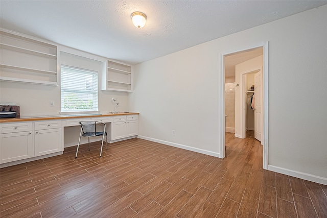 14811 El Miranda Dr, Houston, TX 77095 - interior space with built in study area, baseboards, and wood finished floors