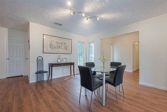 14811 El Miranda Dr, Houston, TX 77095 - dining room featuring a textured ceiling, wood finished floors, and visible vents