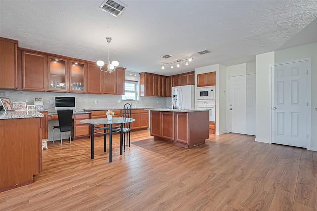 14811 El Miranda Dr, Houston, TX 77095 - kitchen with white appliances, brown cabinets, and visible vents