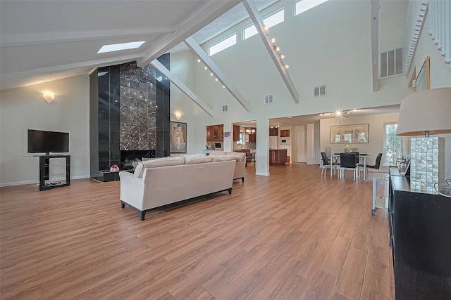 14811 El Miranda Dr, Houston, TX 77095 - living area with visible vents, beamed ceiling, high vaulted ceiling, and light wood-type flooring