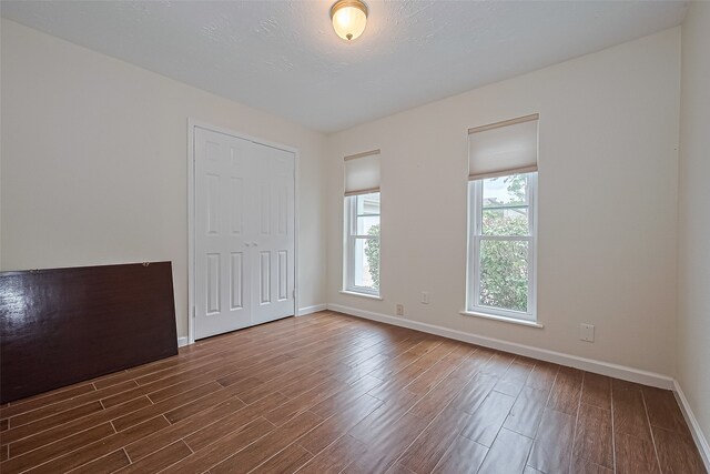14811 El Miranda Dr, Houston, TX 77095 - spare room featuring dark wood-style flooring and baseboards