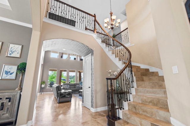 24818 Waterstone Estates Cir W, Tomball, TX 77375 - entrance foyer featuring a towering ceiling, arched walkways, baseboards, a notable chandelier, and stairs