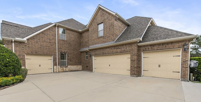 24818 Waterstone Estates Cir W, Tomball, TX 77375 - view of front of house featuring concrete driveway, brick siding, a shingled roof, and a garage