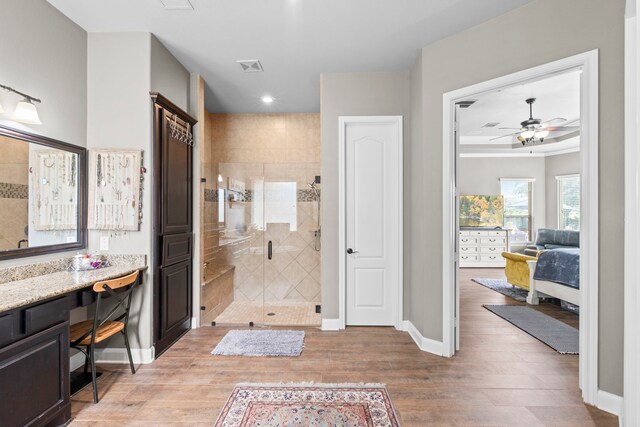 24818 Waterstone Estates Cir W, Tomball, TX 77375 - ensuite bathroom with wood finished floors, ceiling fan, baseboards, and a stall shower