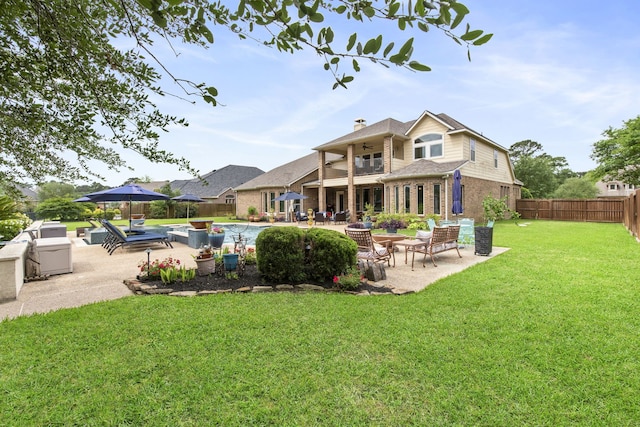 24818 Waterstone Estates Cir W, Tomball, TX 77375 - back of property with a patio area, brick siding, a fenced backyard, a balcony, and a yard
