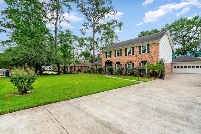 colonial house featuring brick siding, a front lawn, and driveway