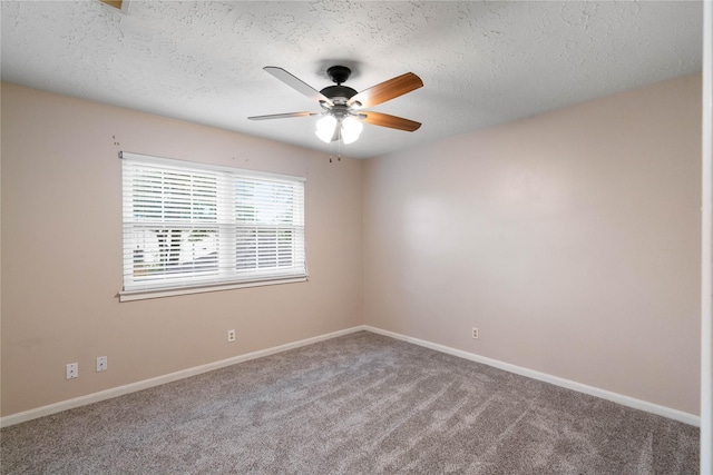 carpeted spare room with baseboards, ceiling fan, and a textured ceiling